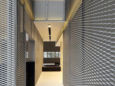 Expanded metal is used as wall, partition and ceiling in an office.